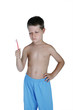 Young boy holding toothbrush and making a face, studio shot