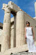 Woman near Propylaea Columns Acropolis Athens Greece on sky back