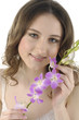 Beautiful girl holding orchid flower in her hands Beautiful girl holding orchid flower in her hands