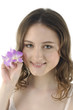 Beautiful girl holding orchid flower in her hands Beautiful girl holding orchid flower in her hands