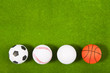 Four balls on fake green grass Four balls on fake green grass