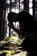 Photo: Man kneeling praying in the forest Man kneeling praying in the forest
