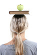 student with apple and book on the head student with apple and book on the head