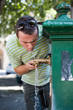 Man Drinking Water from a Public Fountain