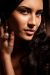 Portrait of young brunette woman with curly hair