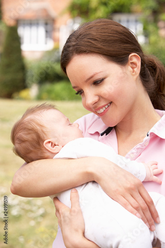 Close Up Of Mother Cuddling Newborn Baby Boy Outdoors At Home Close Up Of Mother Cuddling Newborn Baby Boy Outdoors At Home