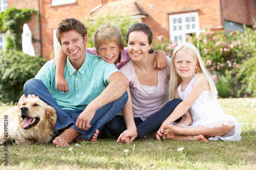 Photo: Family Sitting In Garden Together Family Sitting In Garden Together