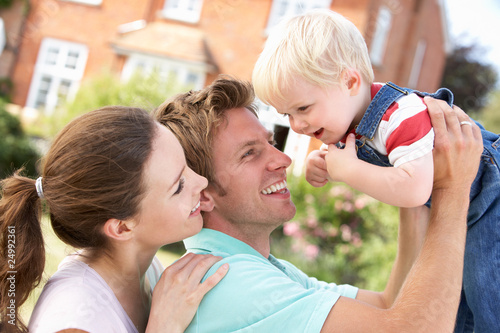 Family Playing Together In Garden At Home