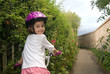 Cheerful girl riding a bike