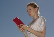Girl holding a book in a red cover Girl holding a book in a red cover