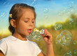 Dreams, little girl blowing soap bubbles at sunset