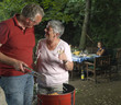 Bbq in the garden with man and woman on foreground