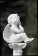 Little sad angel in a cementary
