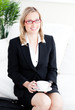Captivating caucasian businesswoman holding a cup sitting on a s Captivating caucasian businesswoman holding a cup sitting on a s