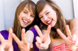 Teenage girls making a peace sign Teenage girls making a peace sign