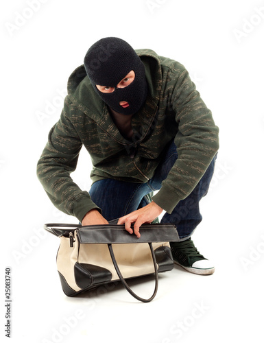 Photo: thief in black balaclava with stolen bag thief in black balaclava with stolen bag