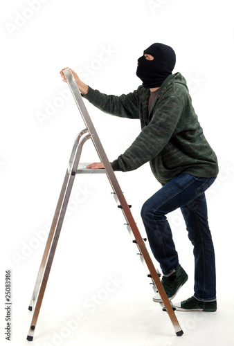 Photo: thief in black balaclava entering on ladder thief in black balaclava entering on ladder