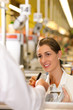 Cashier in supermarket taking credit card