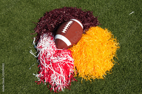 Photo: American Football and Pom Poms on Field American Football and Pom Poms on Field
