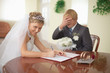 Marriage registration. Bride is happy. Groom in grief. Marriage registration. Bride is happy. Groom in grief.