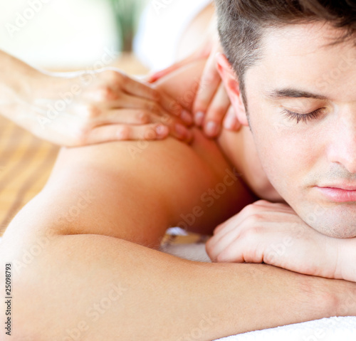 Photo: Close-up of an attractive man having a back massage Close-up of an attractive man having a back massage