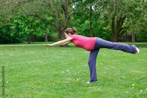 Photo: Pregnant woman exercising in the park Pregnant woman exercising in the park