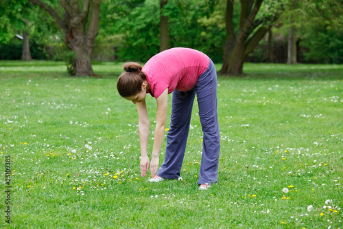 Photo: Pregnant woman exercising in the park Pregnant woman exercising in the park