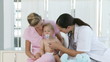 Female Doctor and Nurse with a Baby
