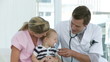 Serious Doctor and blonde Nurse with a Baby