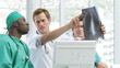 Three doctors discussing an X-ray