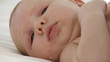 newborn lying on a bed