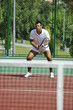young man play tennis outdoor