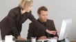 two associates discussing over a desk