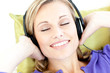 Delighted woman listening to music in the living-room