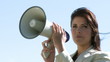 Businesswoman giving intsructions with a megaphone