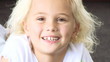cute blond little girl smiling at the camera