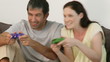 happy couple playing video game in the living room