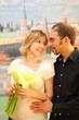 man in glasses embracing beauty blond girl with flowers bouquet,