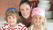 caring mother baking with her children