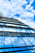 clouds in glazed panel skyscraper