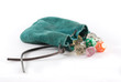 leather pouch with dice falling out on isolated background.