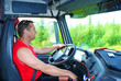 Foto: The driver at the wheel of the truck The driver at the wheel of the truck