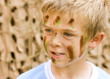 A young boy with camouflage paint on his face