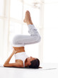 Healthy young woman practising yoga exercise