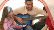 Two happy kids with their dad playing the guitare