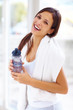 Confident young woman in sportswear holding a water bottle Confident young woman in sportswear holding a water bottle