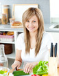 Close-up of a woman cutting cucumber at home
