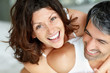 Foto: Playful middle aged couple having fun in bedroom Playful middle aged couple having fun in bedroom