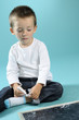 upset boy thinking on numbers and holding chalk upset boy thinking on numbers and holding chalk