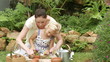 mother and daughter planting in the garden